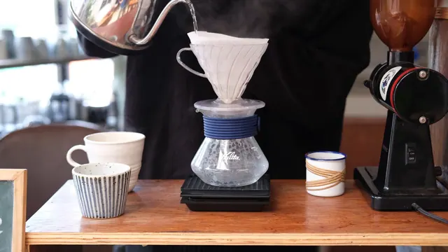 A barista pours hot water over a drip filter to brew fresh coffee. Best Water Filter for Pour Over Coffee in a Small Kitchen