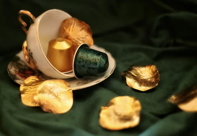 coffee, coffee cup, capsule, gold, green, elegant, cup, petal, still life, coffee pod. Capsules against bulk beans: what each home brewing price tier buys you